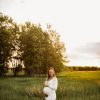 white longsleeve maternity dress photoshoot in marsh