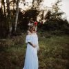 white dress maternity photo dresses in the woods at sunset
